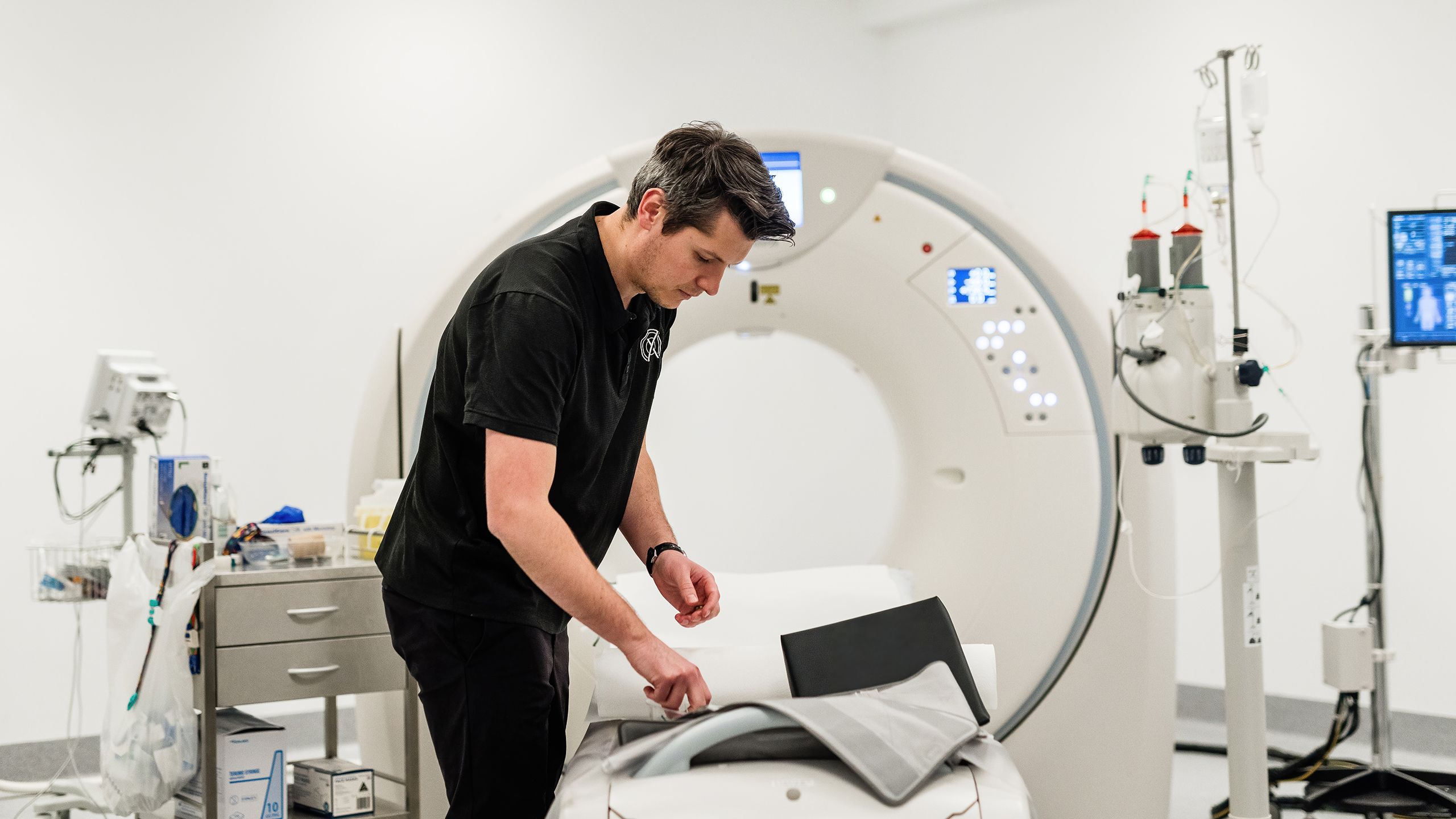 A clinician at Rad X prepares the scan room for the next patient.
