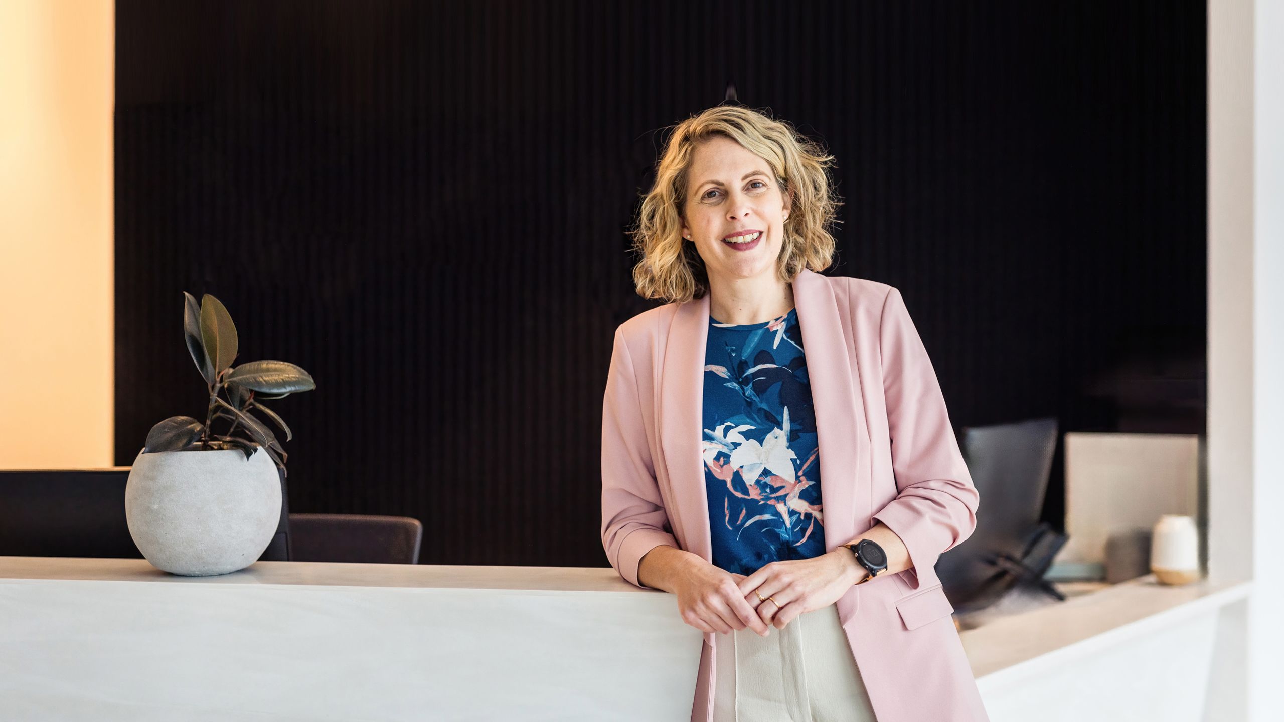 Radiologist, Dr Katie Daniels at the reception desk of her clinic, Rad X in Hobart.