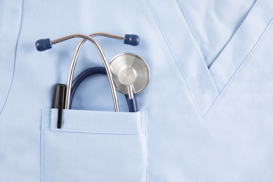 a close up of a pocket on a lab coat that has a stethoscope pocking out of the top. 