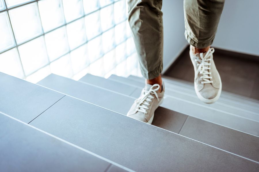 Man ascending office stairs.