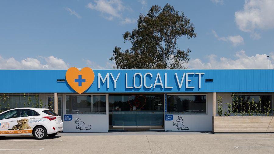 An image of the front facade of Dr Sam Jone's vet practice called My Local Vet. The sign is in blue with a big orange heart with a blue cross in the middle.